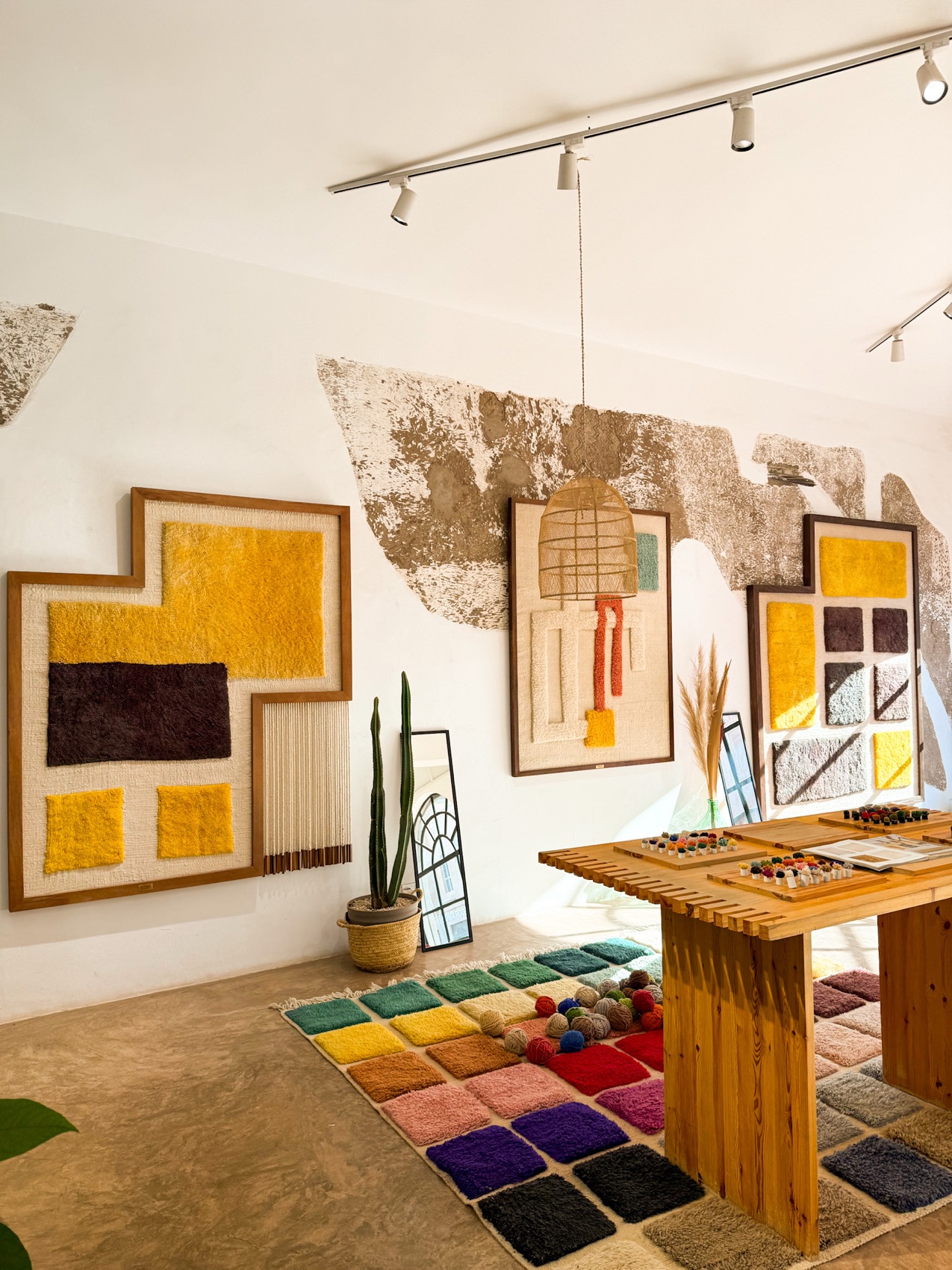 Framed tufted works and the wool sample table
