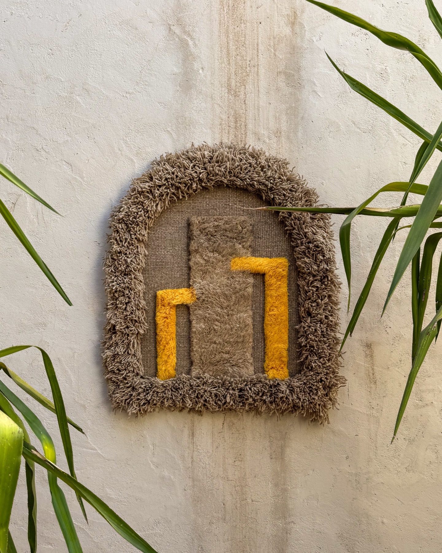 Arched Circuits piece on a textured wall